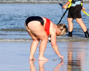 Thick BBW blonde lady in a bikini at the beach