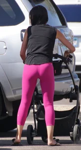 Milf brunette in purplish-pink leggings looking sexy in the parking lot