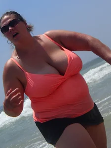 Thick lady on the beach with huge tits