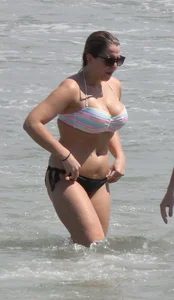 Big boobed thick blonde on the beach in a bikini