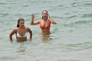 Two sexy ass girls on the beach in bikinis