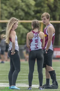 Candid teens in sport uniform and tights on the football field creepshot