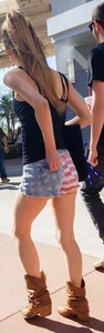Cute girl with glasses in USA shorts showing her cheeks