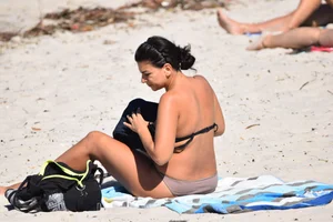 Thick mature brunette bikini lady on the beach with a nice body