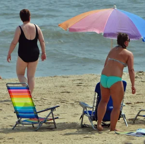 Thick beach girl in a teal bikini