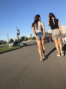 Two Hot Girls on a Street in Denim Shorts and a Skirt - One Touching Her Booty - Creepshots Gallery