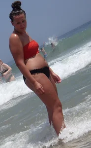 Thick brunette lady on the beach with a big booty