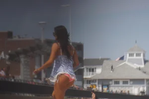 Trio of girls in bikinis on the beach and one with an incredible ass