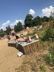 Hot Girl in a Swimsuit Lying on a Bench at the Beach Creepshots