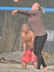Beach volleyball blonde lady in tight leggings