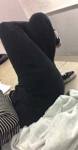 College Candid Girl in Tight Black Jeans Lying on Top of Desk With Crossed Legs Classroom Photo