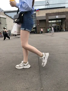Candid Girl in Blue Denim Shorts and Sneakers Walking Down the Street - Hot Legs Crepshots Collection