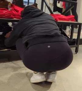 Skinny sports store employee in yoga pants