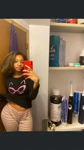Hot girl in sweatpants, selfie in the bathroom mirror