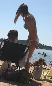 Swedish beach blonde girl in white and green bikini
