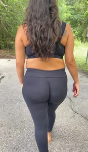 Latina chick with nice wedgie in black tights walking park trail
