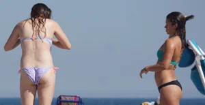 2 cute friends in bikinis on the beach