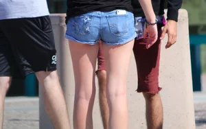 Candid skinny college girl in denim shorts showing some cheeks