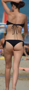 Pale brunette in a black bikini with a nice body at the beach