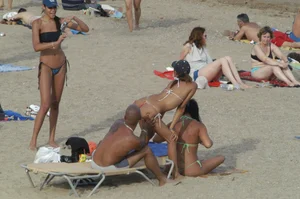 Topless girls on a beach in Barcelona