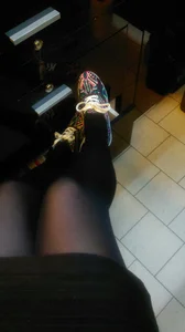 Legs in Black Pantyhose and Candy-Colored Sneakers Selfie Closeup