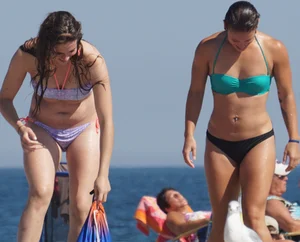 2 cute friends in bikinis on the beach