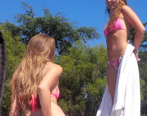 Sexy blonde up close in pink bikini with friend