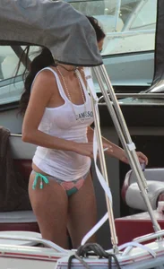 Bikini babe on a boat with a wet see through white shirt showing her tits