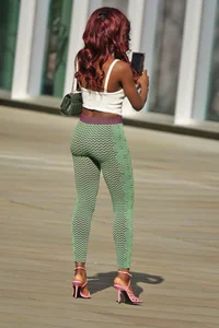 Slim ebony teens in leggings posing in the sun