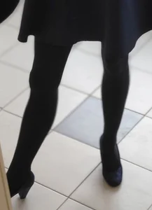 College Teen Wearing a Skirt, Black Pantyhose And Shoes on Heels
