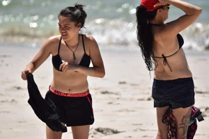 Beach girl can't keep her tits in her bikini