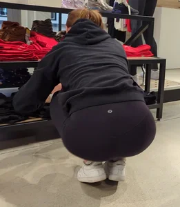Skinny sports store employee in yoga pants