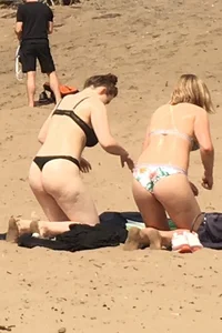 Big boobed babe at the lake in a black thong with blonde friend
