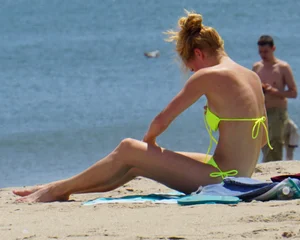 Sexy ass blonde milf on the beach in a thong with cameltoe and bending over