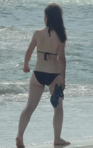 Lady on the beach in black bikini with nice ass