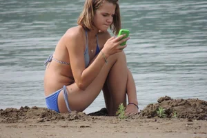 Skinny teen having fun in her little England bikini