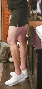 Sexy milf in short tennis skirt shows off perfect legs modeling shoes in shoe store