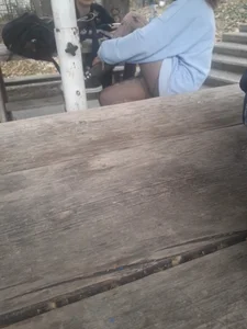 College teen in ripped pantyhose sitting outside