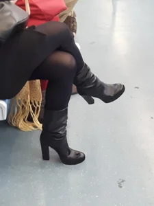 Crossed Legs of a Milf in a Skirt, Black Pantyhose And High-Heeled Boots