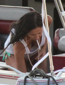 Bikini babe on a boat with a wet see through white shirt showing her tits