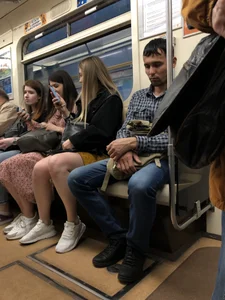Cute candid girl with hot legs sitting in subway train