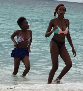 Candid black family, milf and teens on the beach in bikinis