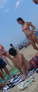 Pierced nipples hottie in pink at the beach