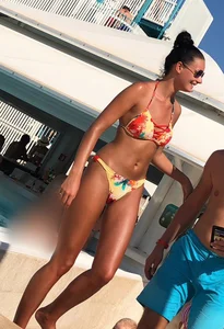 Skinny and sexy tanned bikini girl out at the pool