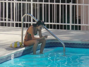 Hot milf sunbathing in a thong by pool and swimming