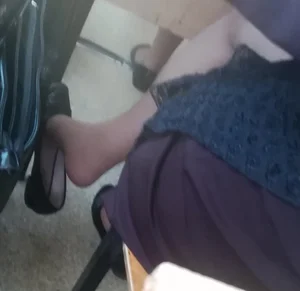 College Girl's Feet With Flats Half Taken Off Closeup Under Desk