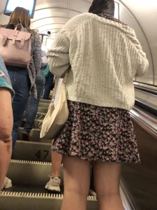 Candid Girl in Sandals and a Dress Standing With Spread Legs On the Subway Escalator
