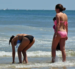 Two teen friends in bikinis at the beach