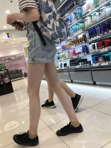 Girl in Blue Denim Shorts with Very Skinny Legs Store Candid
