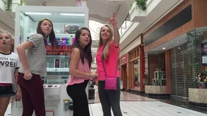 Little blonde teen in grey leggings at the mall with her friends